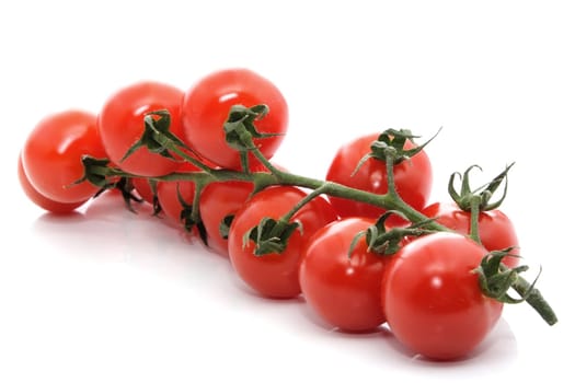 cluster of small tomatoes isolated on white