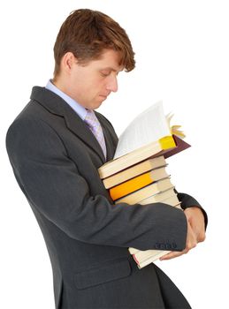 A man reading a book while standing in the library