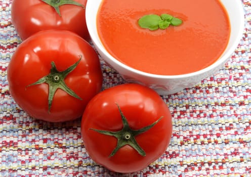 tomato soup in white bowl, red background