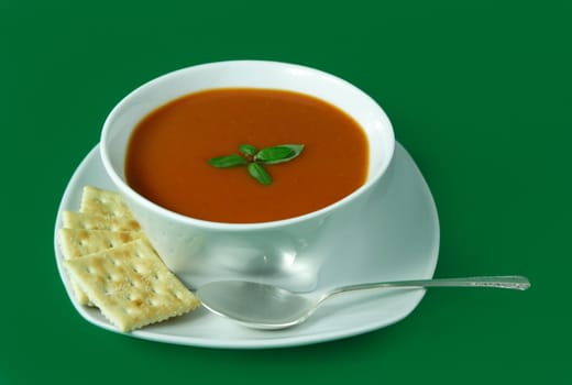 bowl of tomato soup with crackers