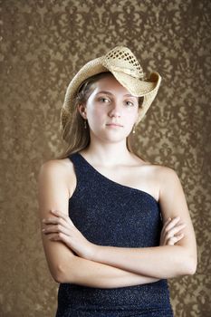 Confident Young Girl in a Blue Dress and Cowboy Hat