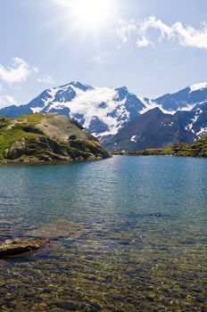 summer view of Black Lake against the light, Trentino, Italy