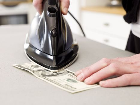 Ironing a hundred dollar bank note