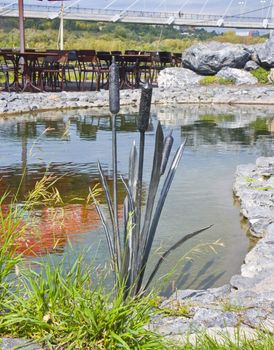 The image of a metal cane among a usual grass