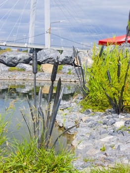 The image of a metal cane among a usual grass