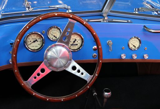 Vintage sports car with blue instrument panel.