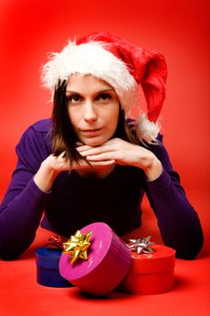 A young woman with a present isolated on red