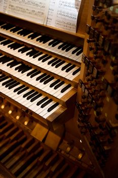 An old pipe organ keyboard in a church