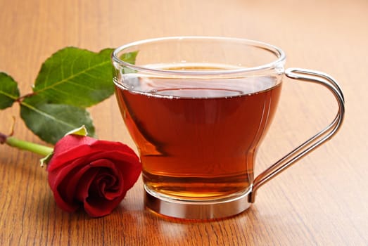 cup of tea with a red rose