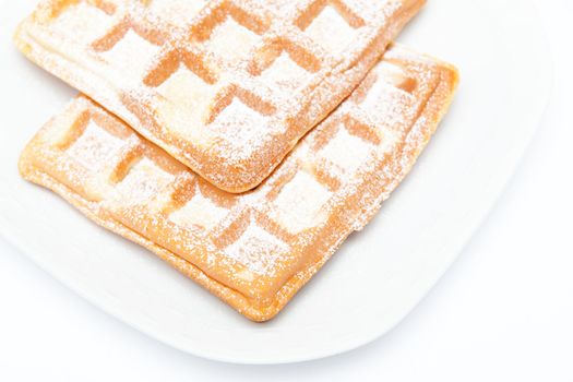 Two waffles on the white plate