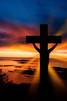 A cross at sundown on the ocean