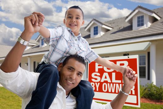 Excited Hispanic Father and Son with For Sale By Owner Sign in Front of House.