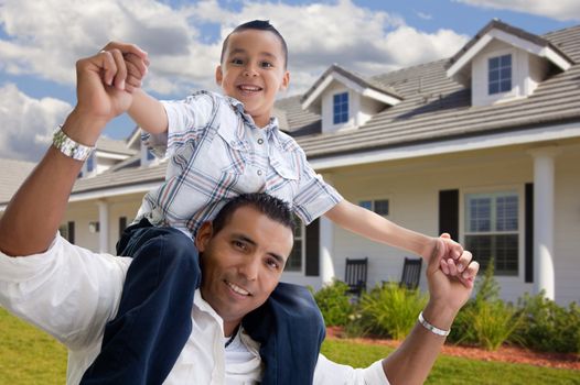 Playful Hispanic Father and Son in Front of Beautiful House.