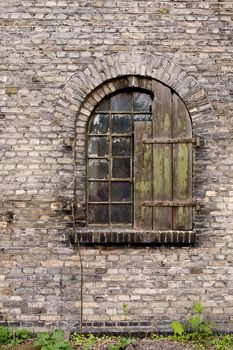 An old antique window on a brick building