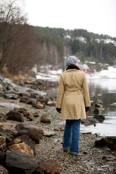 A woman standing near the ocean