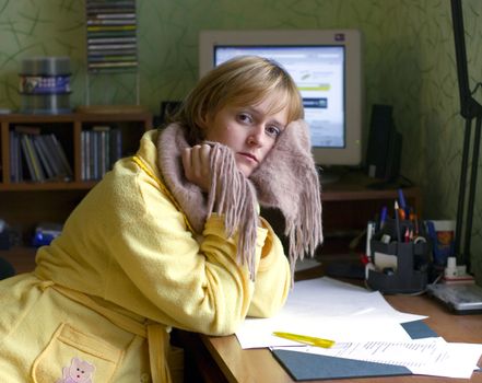 The image of the girl with a scarf on a neck in a house interior