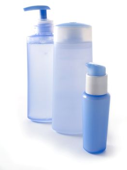 blue cosmetic bottles without labels isolated on white background