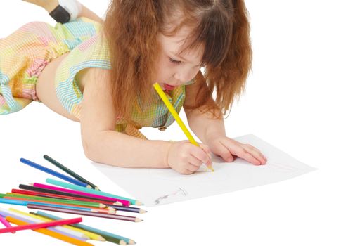 Child draws a picture with colored pencils on a white background