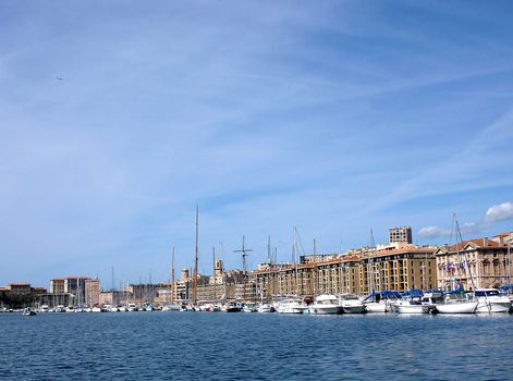 Old port of Marseilles with buildings, boats and Mediterranean sea by beautiful weather