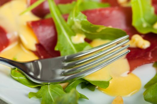 closeup of a ham sandwich with rocket salad