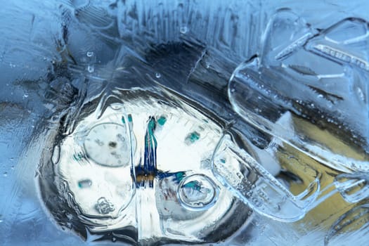 Closeup of wrist watch and water drops inside ice