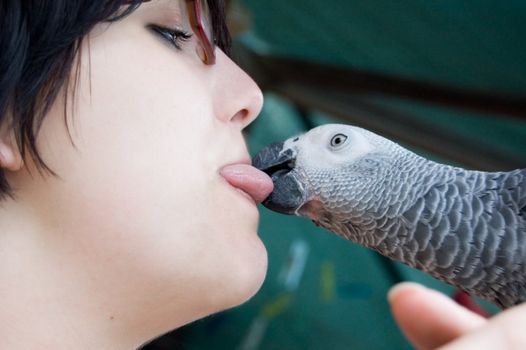 young woman with a grey parrot