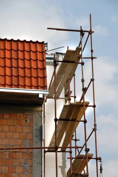 Scaffolding on building corner on construction site