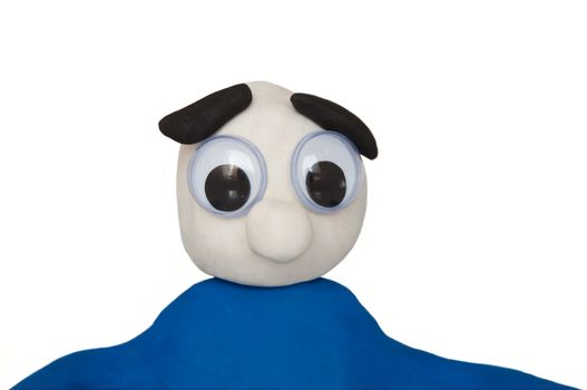 Close and low level of an isolated over white plasticine character with a blank and bewildered expression.