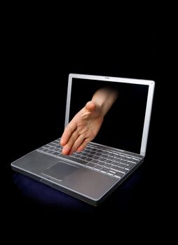 A hand reaching through the computer screen in a hand shaking gesture
