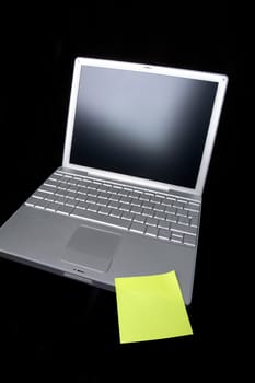 A sticky note on a laptop computer - remember this