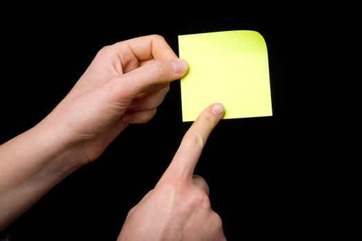 A blank sticky note stuck to a hand - remember this