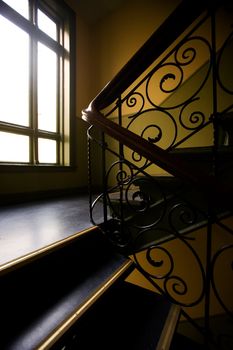 A staircase with a art nouveaux banister