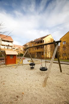 A swing set in a apartment block area