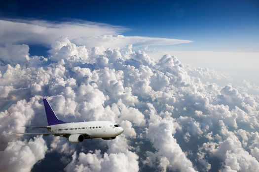 An airplane in flight over clouds