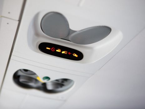 A no smoking and buckle up sign on an airplane