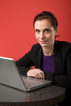 A young woman working on a latptop computer