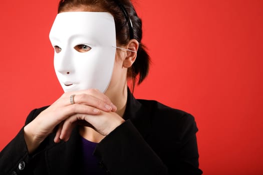 A young business woman behind a white mask