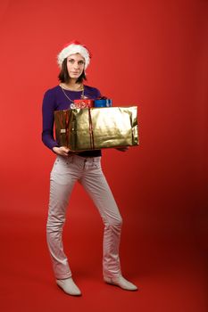 A young woman with a present isolated on red