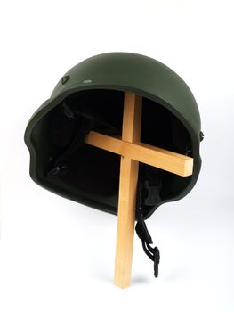 Military helmet on a cross