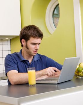 A young male looks at some disturbing information on the computer