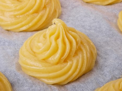 Baker making Choux pastry dough