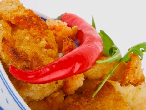 Baked shrimp in a bowl. close up on white background