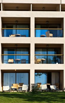 Empty balconies with chairs and tables at Greek hotel