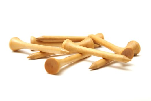 A bunch of wooden golf tees isolated on white.