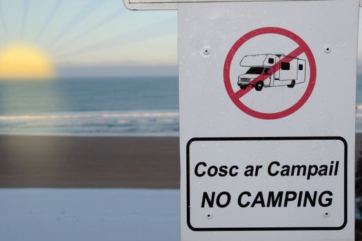 a no camping and motorhome sign in ireland at sunset