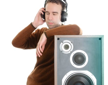A young man listening to some music while resting against a speaker, isolated against a white background