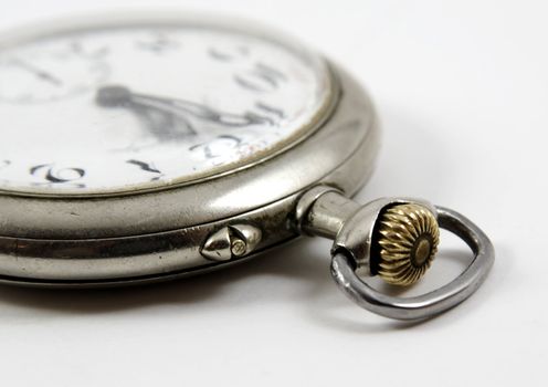 Detail of ancient silver watch isolated over white background