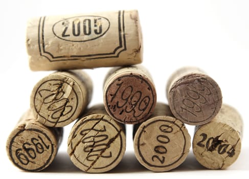 Wine corcks with year stamp on them over white background