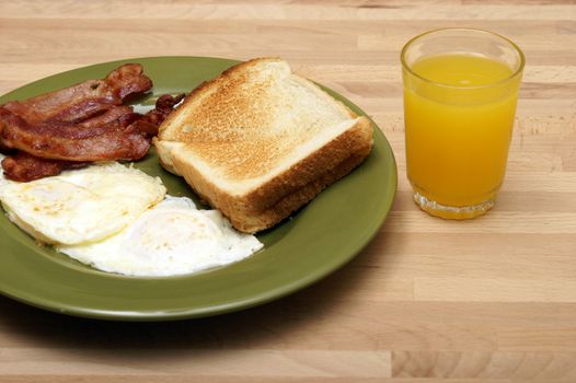 A cooked breakfast of bacon and eggs.