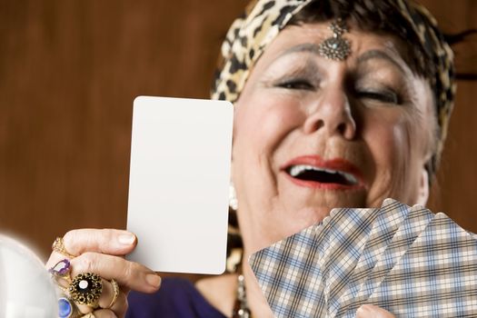 Gypsy fortune teller holding a blank tarot card